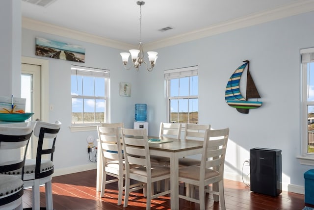 dining room featuring an inviting chandelier, dark hardwood / wood-style floors, and ornamental molding