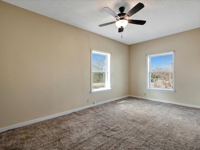 unfurnished room with ceiling fan, carpet floors, and a textured ceiling