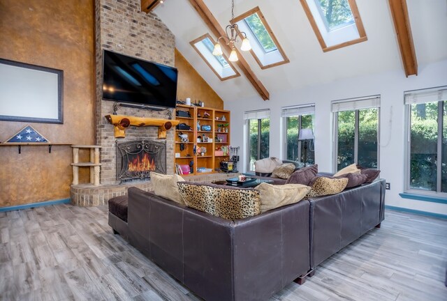 living room with a skylight, a healthy amount of sunlight, and beamed ceiling