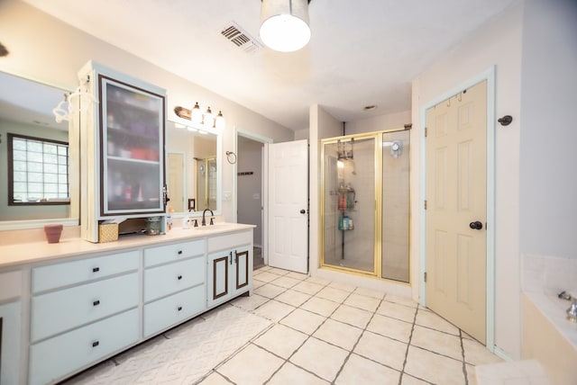 full bathroom with visible vents, a stall shower, vanity, tile patterned flooring, and a bath