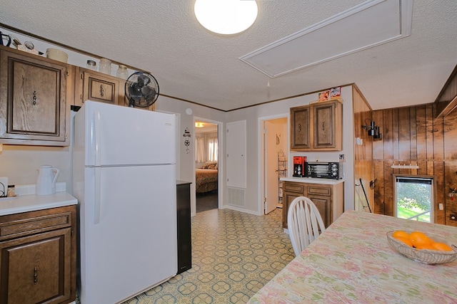 210 Cedar Rdg, Hemphill, TX 75948 - kitchen with light countertops, light floors, freestanding refrigerator, and a textured ceiling
