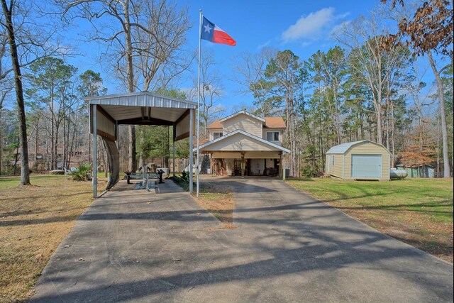 210 Cedar Rdg, Hemphill, TX 75948 - exterior space featuring a shed, driveway, a front lawn, a carport, and an outdoor structure
