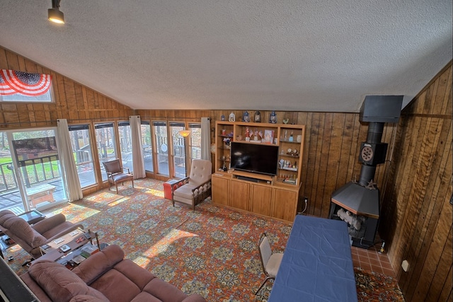 210 Cedar Rdg, Hemphill, TX 75948 - carpeted living area featuring wood walls, a textured ceiling, and lofted ceiling