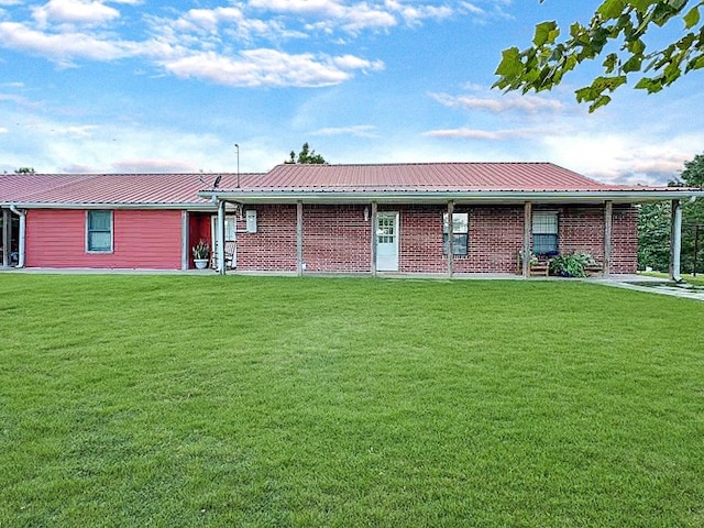 341 Red Wolf Ln, Brookeland, TX 75931 - ranch-style home featuring a front yard, brick siding, and a metal roof