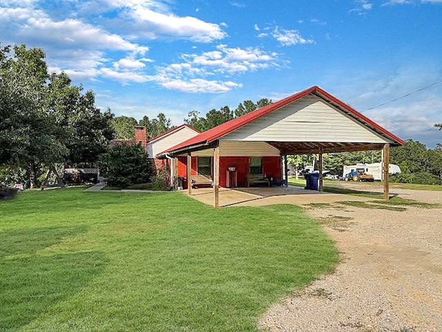 341 Red Wolf Ln, Brookeland, TX 75931 - view of community with a lawn, dirt driveway, and an attached carport