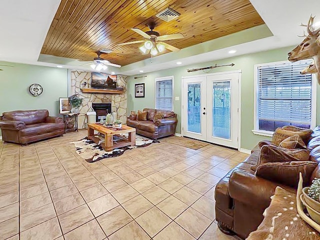 341 Red Wolf Ln, Brookeland, TX 75931 - living room with a tray ceiling, wood ceiling, light tile patterned floors, ceiling fan, and french doors
