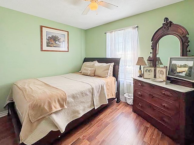 341 Red Wolf Ln, Brookeland, TX 75931 - bedroom featuring dark wood-type flooring and a ceiling fan