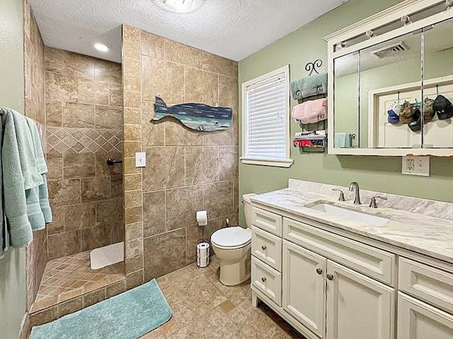 341 Red Wolf Ln, Brookeland, TX 75931 - bathroom featuring walk in shower, a textured ceiling, vanity, and tile patterned floors
