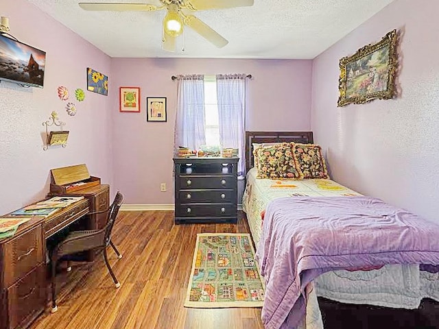 341 Red Wolf Ln, Brookeland, TX 75931 - bedroom with wood finished floors, a textured ceiling, and ceiling fan