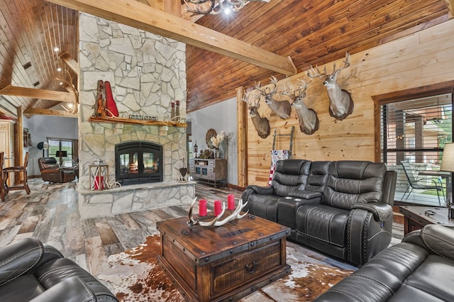 living room with wood-type flooring, high vaulted ceiling, wooden ceiling, beamed ceiling, and a stone fireplace