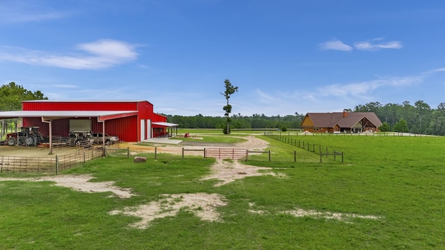 view of yard featuring an outbuilding and a rural view