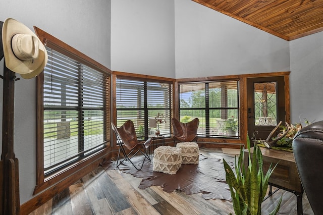 sunroom / solarium with a wealth of natural light, wood ceiling, and lofted ceiling