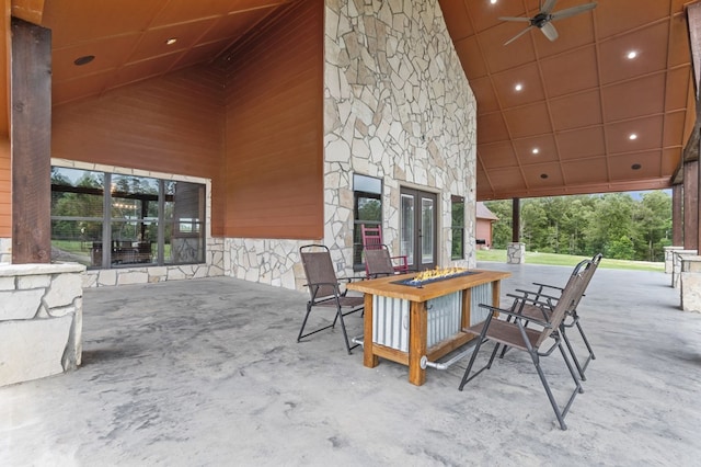 view of patio / terrace featuring french doors, a fire pit, and ceiling fan