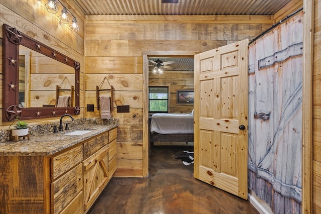 bathroom featuring wood ceiling, concrete flooring, vanity, ceiling fan, and wooden walls