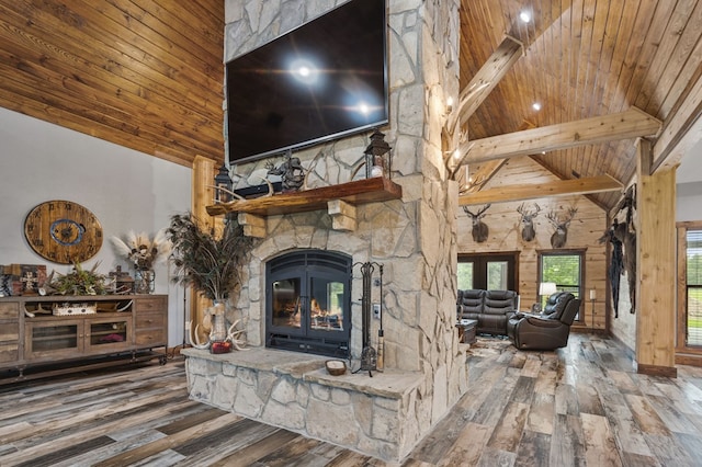 unfurnished living room with a fireplace, hardwood / wood-style flooring, high vaulted ceiling, and wooden ceiling