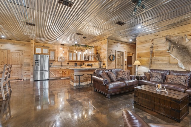 living room featuring ceiling fan and wood walls