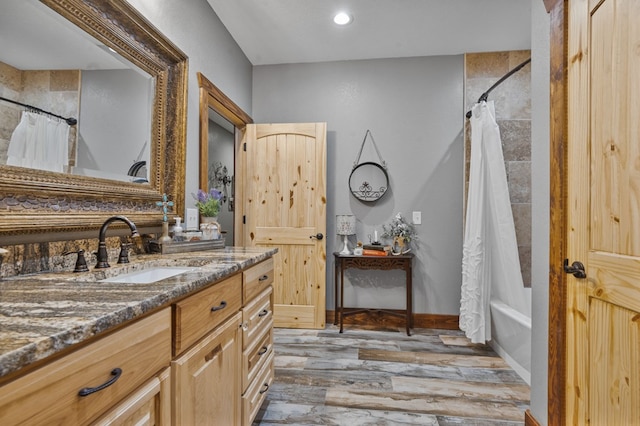 bathroom with vanity, wood-type flooring, and shower / tub combo