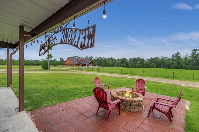 view of patio / terrace featuring a rural view and an outdoor fire pit