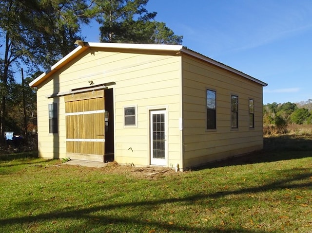 view of outbuilding featuring a yard