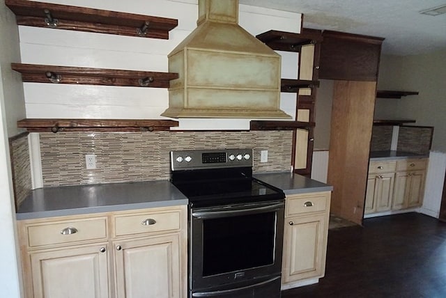 kitchen featuring cream cabinets, range with electric cooktop, and backsplash