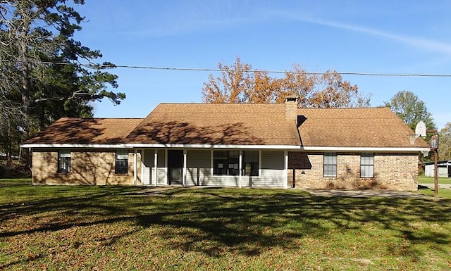 rear view of property with a yard