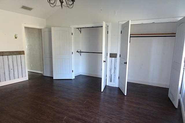 unfurnished bedroom with a chandelier, dark wood-type flooring, a closet, and lofted ceiling