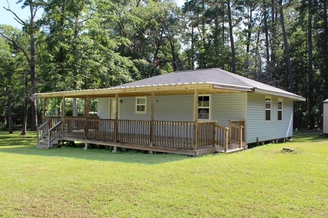 rear view of house featuring a yard