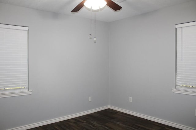 spare room featuring dark hardwood / wood-style floors and ceiling fan