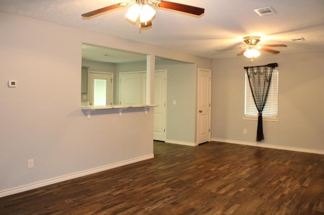 empty room featuring dark hardwood / wood-style floors and ceiling fan