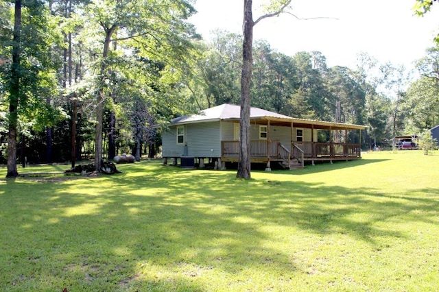 view of yard with central AC unit and a wooden deck