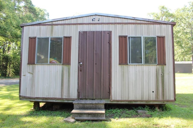 view of outbuilding featuring a lawn