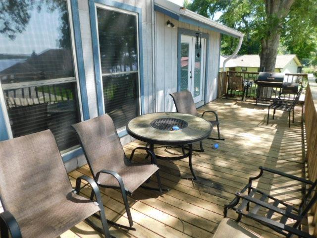 wooden deck featuring french doors and a fire pit