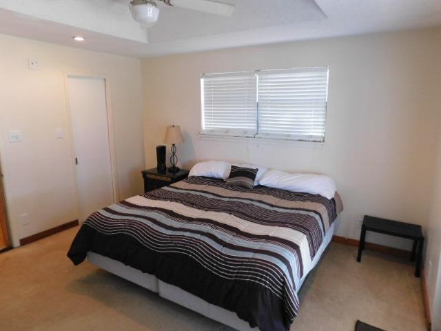 bedroom featuring light carpet and ceiling fan