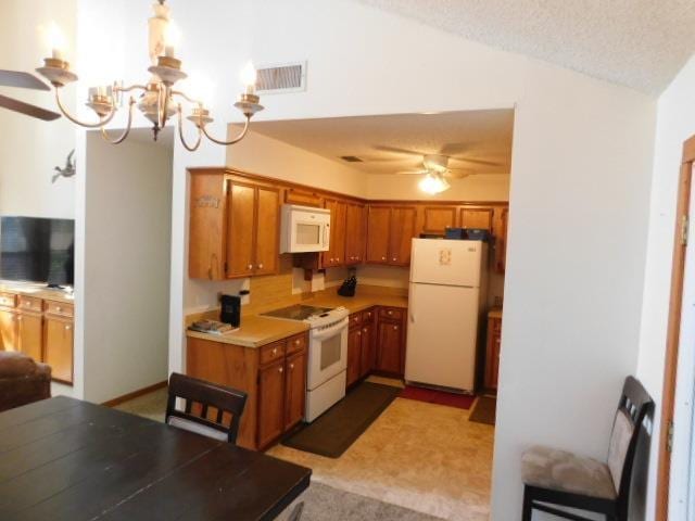 kitchen with carpet floors, a textured ceiling, lofted ceiling, white appliances, and ceiling fan with notable chandelier