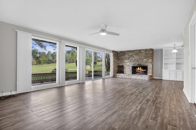 unfurnished living room featuring ceiling fan, a fireplace, built in features, and dark hardwood / wood-style floors