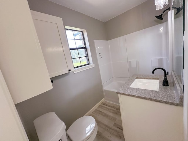 213 Crosstimbers St, Lufkin, TX 75904 - full bath with toilet, vanity, baseboards, shower / bath combination, and wood finished floors