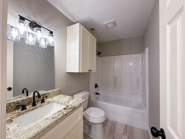 213 Crosstimbers St, Lufkin, TX 75904 - full bathroom featuring vanity, toilet, wood finished floors, and shower / tub combination