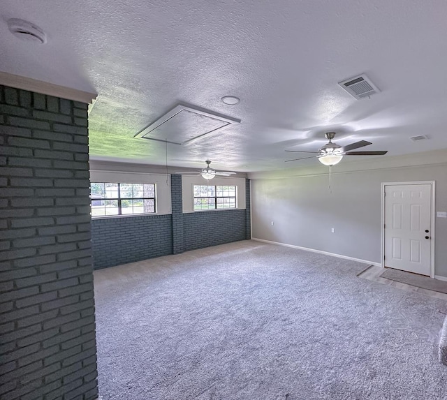 213 Crosstimbers St, Lufkin, TX 75904 - spare room featuring attic access, a ceiling fan, carpet floors, a textured ceiling, and baseboards