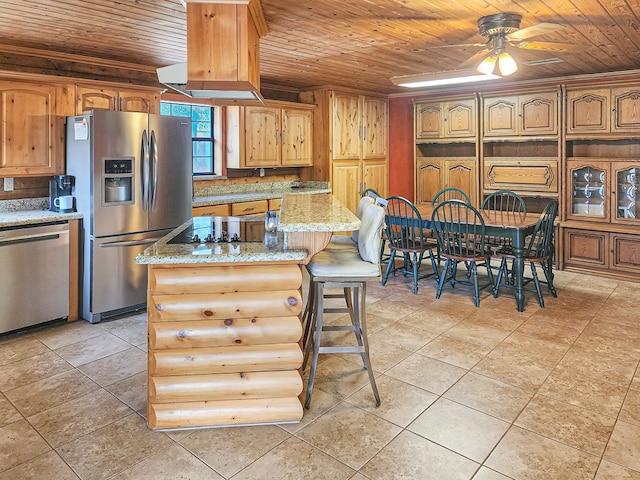 kitchen with appliances with stainless steel finishes, a kitchen breakfast bar, wood ceiling, and light stone counters