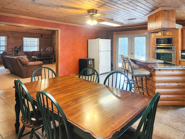 dining area with wood ceiling, log walls, a wealth of natural light, and ornamental molding