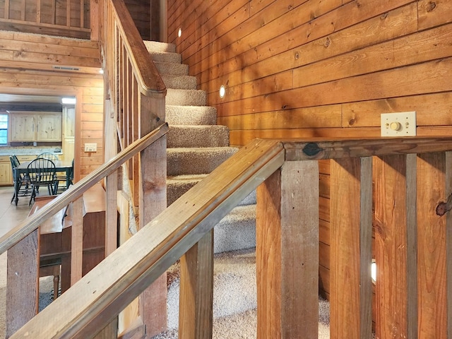 staircase with wood walls and a sauna