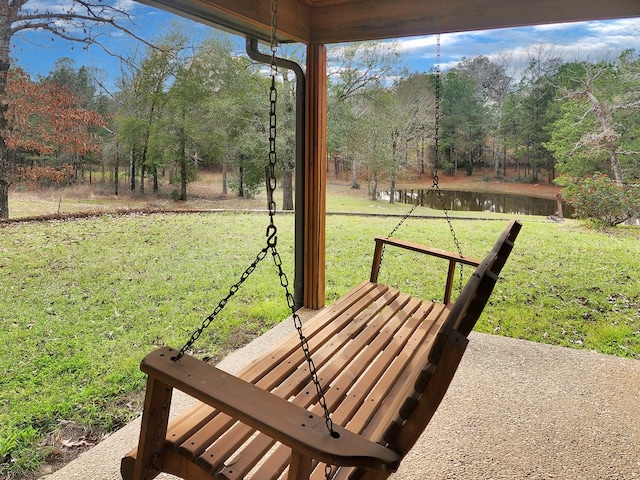 view of property's community featuring a lawn and a water view