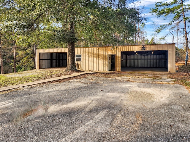 view of gate with an outbuilding and an outdoor structure