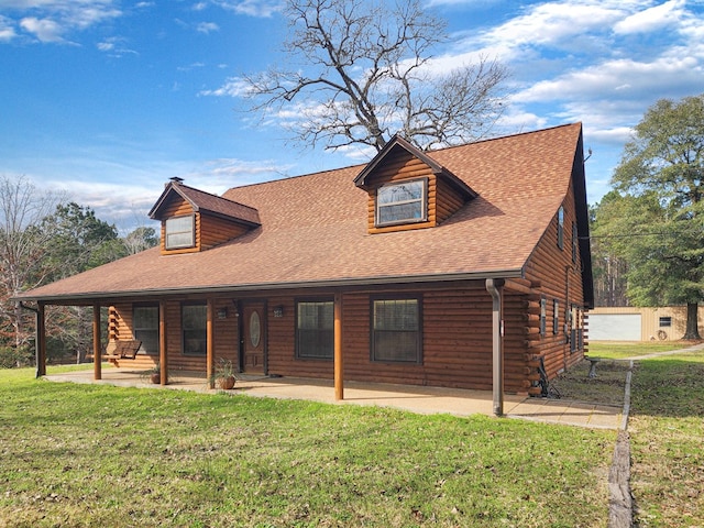 log-style house with a shingled roof, a patio, log exterior, and a front yard