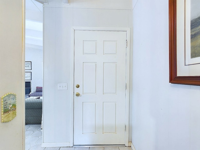 doorway to outside with light tile patterned flooring