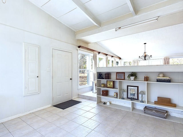 tiled entrance foyer featuring an inviting chandelier and lofted ceiling with beams