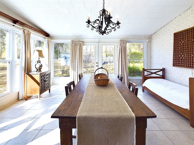 sunroom / solarium featuring a notable chandelier and french doors