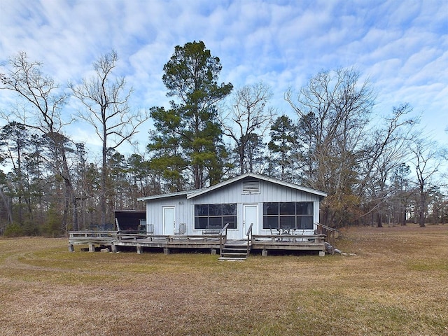 rear view of property with a yard