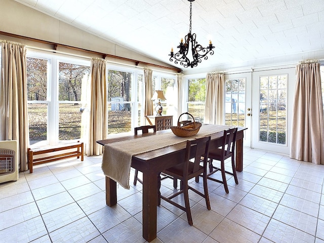 dining area with lofted ceiling, light tile patterned floors, a wealth of natural light, and heating unit