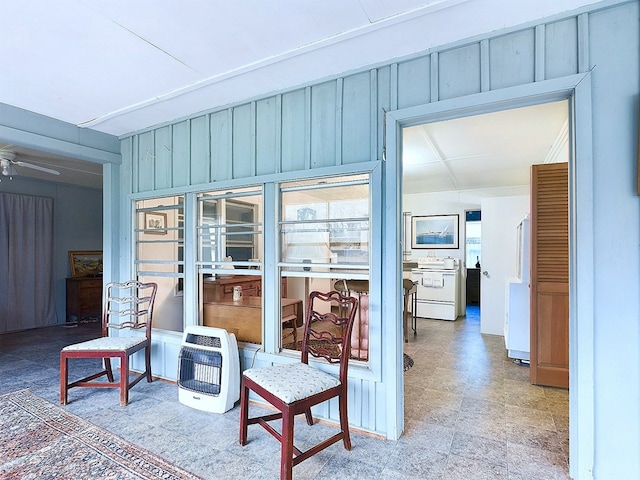 interior space featuring heating unit and ceiling fan